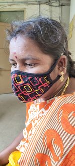 Close-up of woman wearing mask looking away