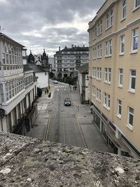 Street amidst buildings in city against sky