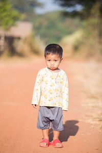 Full length of cute boy standing outdoors