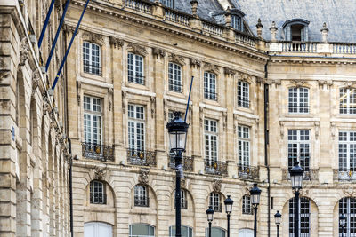 Scenic view of town hall windows next to street lamp