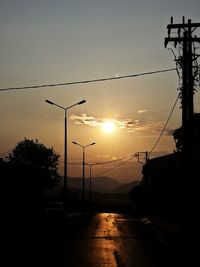Silhouette street light against sky during sunset