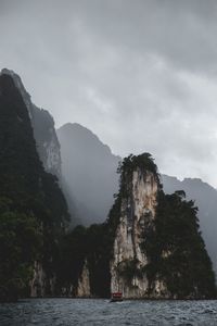 Scenic view of sea and mountains against sky