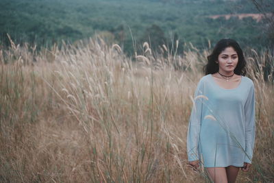 Young woman standing on field