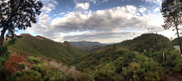 Scenic view of mountains against cloudy sky