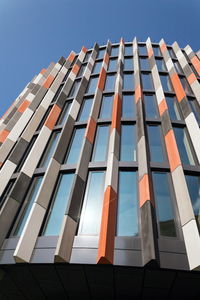 Low angle view of modern building against clear blue sky