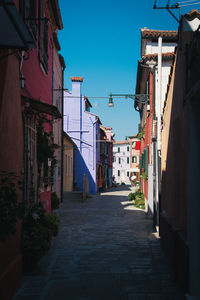 Narrow alley amidst buildings in city