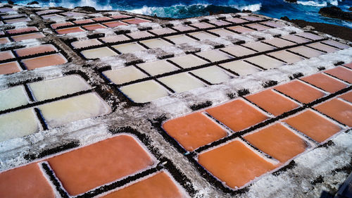 High angle view of salt flat sea salk farm water fields multicolour texture background 