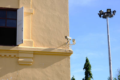 Low angle view of street light against building
