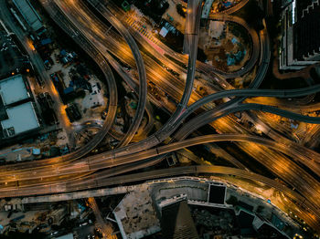 Aerial view of light trails on highway in city