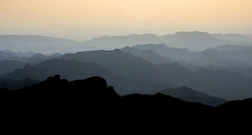 Scenic view of silhouette mountains against sky during sunset