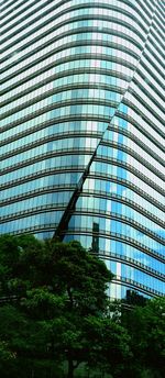 Low angle view of modern building against blue sky