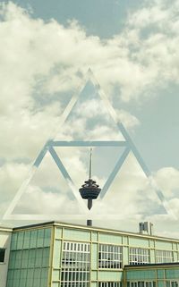Low angle view of modern building against cloudy sky