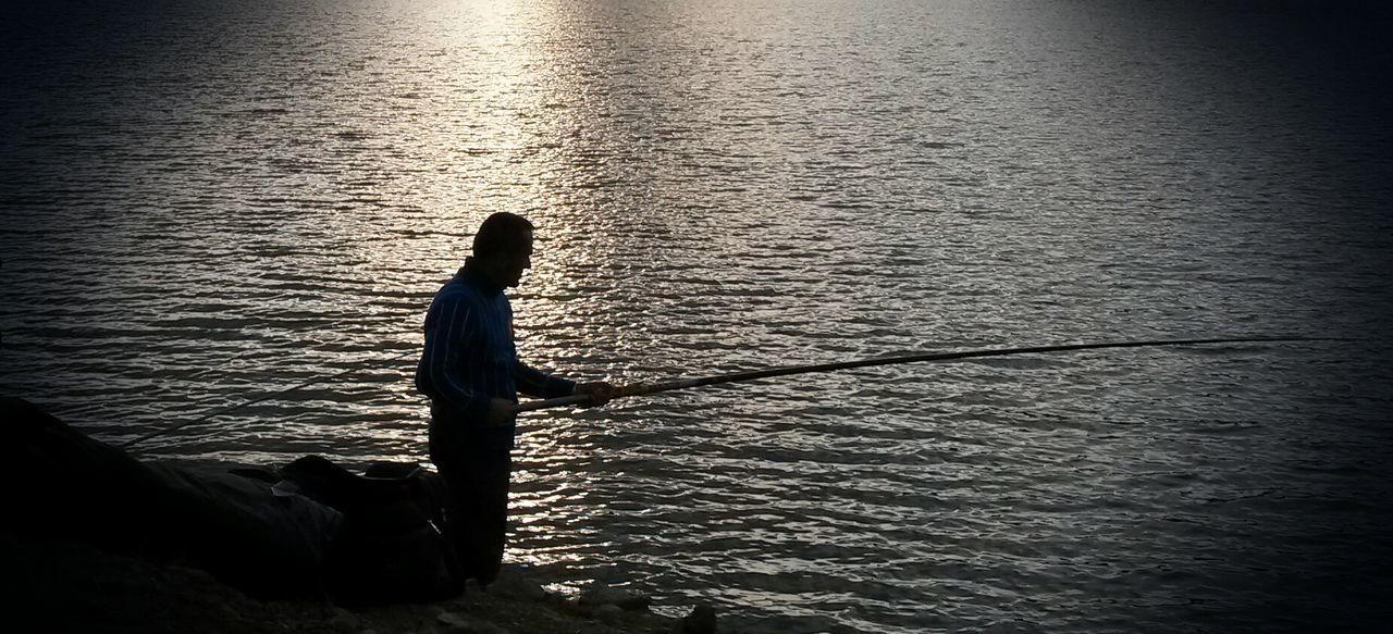 water, silhouette, rippled, sea, waterfront, high angle view, sunset, reflection, tranquility, nature, lake, tranquil scene, men, beauty in nature, outdoors, sunlight, fishing, scenics