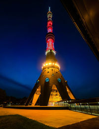 Low angle view of illuminated building against sky at night