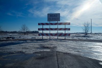 Road sign against sky