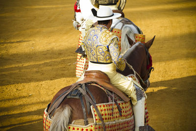 Midsection of man standing in traditional clothing