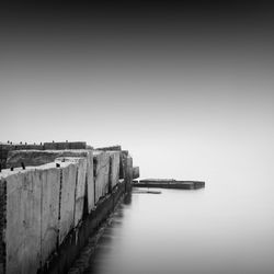 Pier by sea against sky during foggy weather