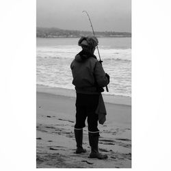 Full length of a boy fishing in sea