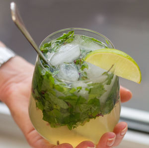 Close-up of cropped hand holding cocktail