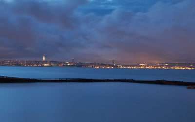 Illuminated city at waterfront