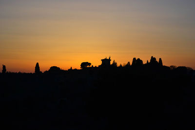 Silhouette landscape against sky during sunset