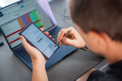 Close-up of woman using digital tablet