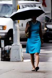 Rear view of woman walking on street