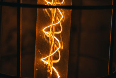 Close-up of illuminated lantern against wall
