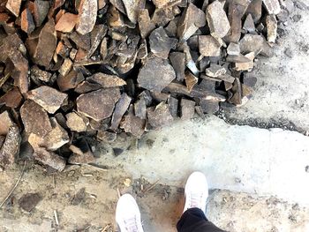 Low section of man standing on rock