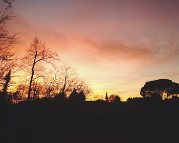Silhouette of trees against sky at sunset
