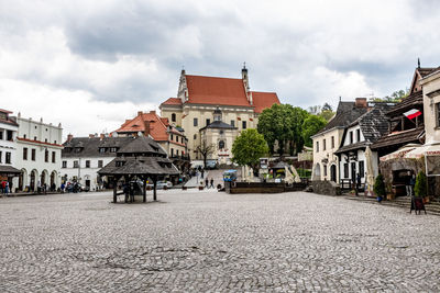 People on street amidst buildings in town