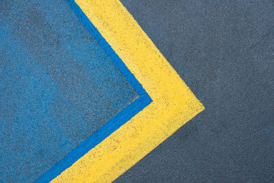 High angle view of yellow lines on car park 