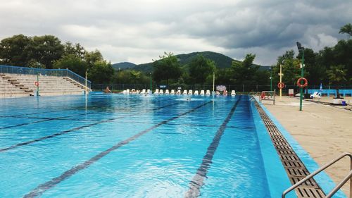 Swimming pool against cloudy sky