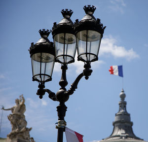 Low angle view of street light against building