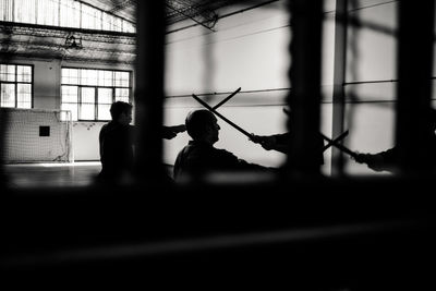 Silhouette people walking on wall