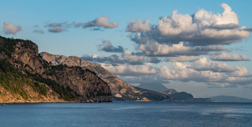 Scenic view of sea and mountains against sky