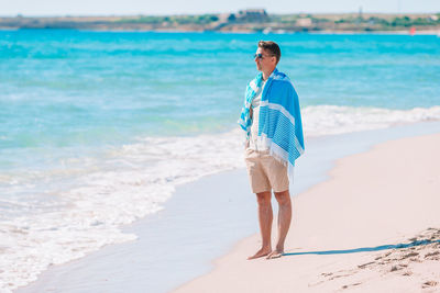 Full length of man standing on beach