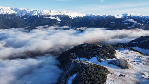 Aerial view of snowcapped mountains against sky