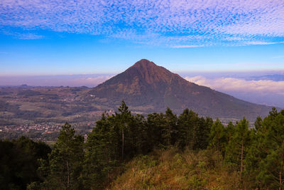 Scenic view of mountains against blue sky