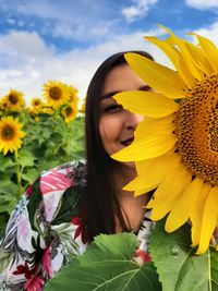 Close-up of woman with yellow sunflower