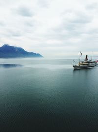 Boat sailing on sea against sky