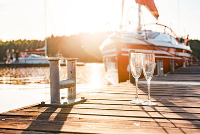 Two empty glasses on the dock. horizontal photo