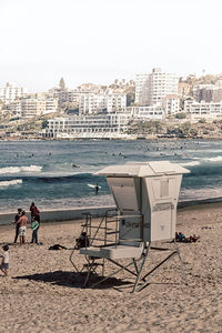 Deck chairs on beach against clear sky