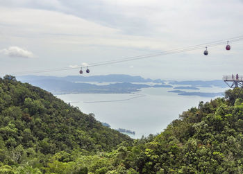 Overhead cable cars against sky