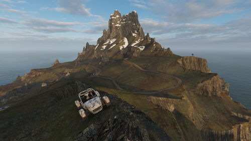 Scenic view of sea and mountains against sky