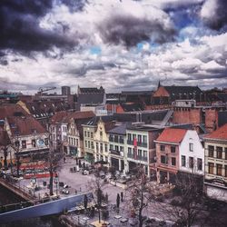 Buildings against cloudy sky