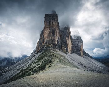 Great wall of mountain against cloudy sky