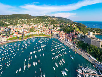 High angle view of townscape by sea against sky