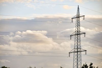 Low angle view of electricity pylon against sky