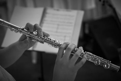 Close-up of person playing wind instrument